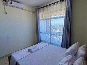 Postel nebo postele na pokoji v ubytování Classic 2 bedroom penthouse in mombasa CBD + 2 fotografie