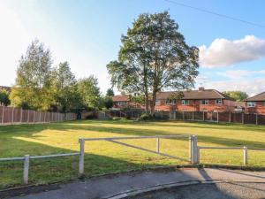 a fence in the middle of a field at Ash House in Broadheath