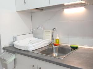 a kitchen counter with a sink and a cutting board at NEW JASMINe in Tenerife +63 photos
