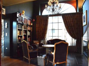 a room with chairs and a table and a chandelier at Family fun near Redu center in Redu
