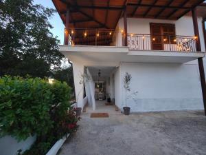 a house with a balcony with lights on it at Tenuta Le Pietre Bed & Breakfast in San Donato Val di Comino