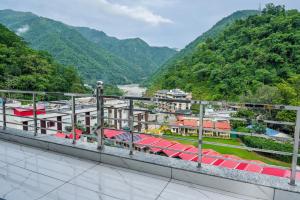 a view from the balcony of a resort with mountains at The Nature's Nook - Best Stay in Shivpuri, Rishikesh, Hotel & Rooms in Shivpuri