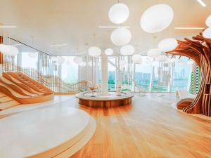 a large room with white lights and wooden floors at Fairmont Doha in Doha
