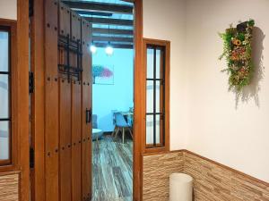 a room with a door and a table with an umbrella at La Casita de Ale Casa Rural cerca Puy du Fou in Polán