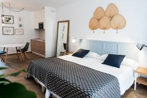 a bedroom with a large bed and a table at Los Cardones Boutique Village in Playa de las Americas