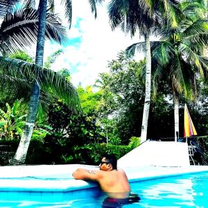a man laying on a mattress in a swimming pool at family home in Honda