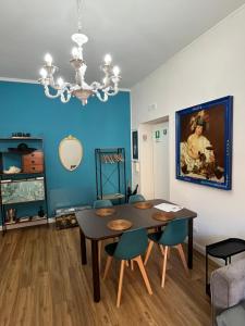 a dining room with a table and chairs and a painting at SPAZIO apARTment di stile METROC 8 stops to COLOSSEO in Rome
