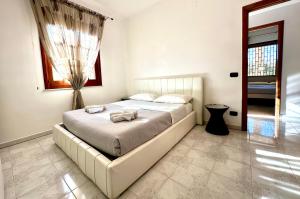 a bedroom with a large bed in a room at Arenella Blu Holidays in Arenella