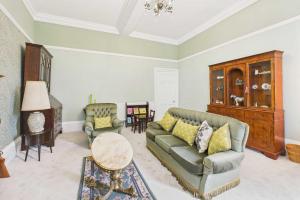 a living room with a couch and a table at Host & Stay - Thorneville House in Knaresborough +25 photos