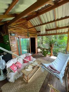 a room with a bed and a hammock in a house at Forest Retreat House Hammock & Private Terrace in Ban Nok