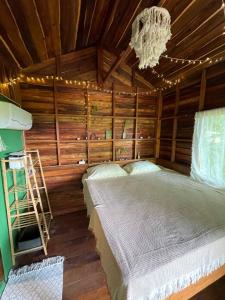 a bedroom with a bed and a chandelier at Forest Retreat House Hammock & Private Terrace in Ban Nok