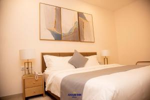 a bedroom with a bed and two lamps on a night stand at Amani inn hotel in Kinshasa