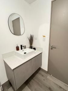 a bathroom with a white sink and a mirror at Original Studio ESCALANTE in San José +36 photos