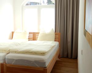 a bedroom with two beds in front of a window at Charmantes Apartment - zentral gelegen - am Schwarzwaldrand in Nagold