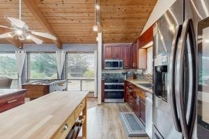 a kitchen with wooden cabinets and a refrigerator at Ocean Star in Sea Ranch
