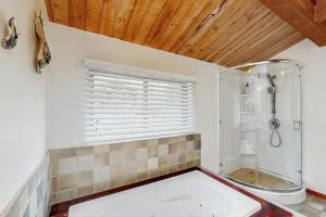 a white bathroom with a shower and a tub at Ocean Star in Sea Ranch +17 photos