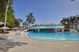 a large swimming pool with a building in the background at Modern Escape with Pool & Beach in Puerto Plata