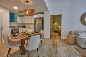 a kitchen and living room with a table and chairs at Modern Escape with Pool & Beach in Puerto Plata