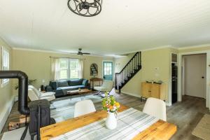a living room with a table and chairs at Cozy Cottage in Glen Spey in Glen Spey