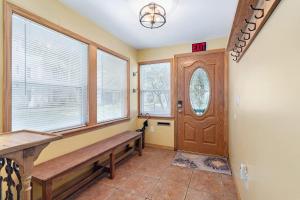 a hallway with a wooden bench and a door at Downtown Gem- Dog Friendly Walk to Everything in St. Augustine