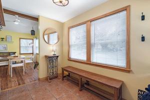 a living room with a bench and a table at Downtown Gem- Dog Friendly Walk to Everything in St. Augustine +44 photos