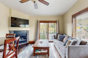 a living room with a couch and a fireplace at Modern Grand Lake Luxury in Grand Lake
