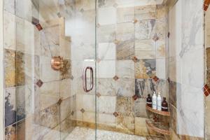 a bathroom with a shower with a glass door at Modern Grand Lake Luxury in Grand Lake +15 photos