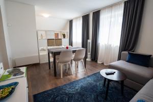 a living room with a table and a couch at Studio Katarina in Delnice