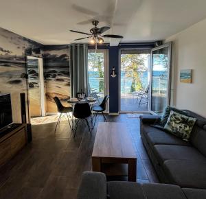 a living room with a couch and a table at Baltic Crown - Premium Sea View Rewal in Rewal