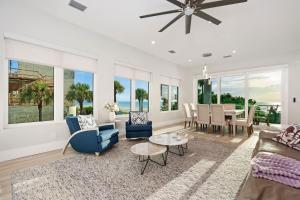 a living room with a couch and a table at Luxury Family Beachfront Oasis Pool Spa and Views in Clearwater Beach +56 photos