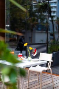 a white table with two chairs and flowers on it at Suites By Le Rêve in Tangier