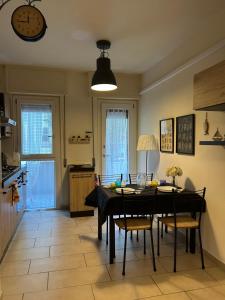 a dining room with a table and chairs and a clock at Gardenia Guest House in Marina di Massa +25 photos