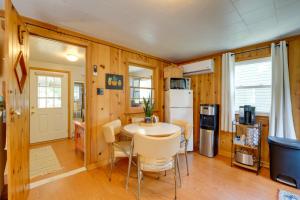 a kitchen with a table and chairs and a refrigerator at Walk to Beach Access! Chic Port Austin Studio in Port Austin