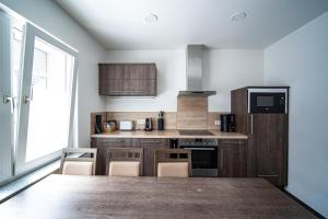a kitchen with a large wooden table with chairs in it at Blauer Stein - Vibe WH02 in Pulheim