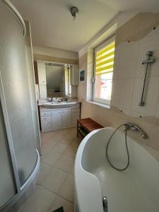a bathroom with a bath tub and a sink at Machy Liptov in Liptovská Kokava +24 photos