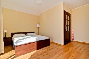 a bedroom with a bed and a wooden floor at HORN Jastarnia in Jastarnia