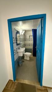 a bathroom with a toilet and a sink at Fairly new one bedroom guest house in Ariana +4 photos