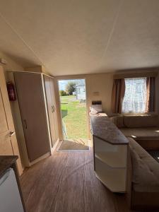 a small caravan with a kitchen and a living room at Singh&Leite Family caravan for 6 people in Saint Osyth