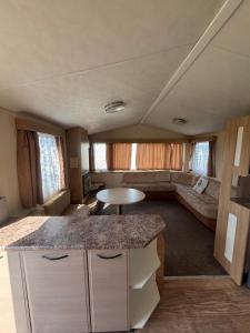 a kitchen and living room of an rv at Singh&Leite Family caravan for 6 people in Saint Osyth +14 photos