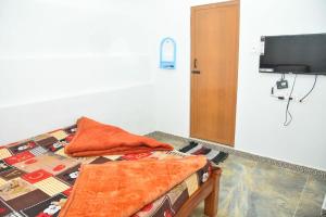 ein Bett mit zwei Kissen darauf in einem Zimmer in der Unterkunft Murugan Homestays in Vālpārai