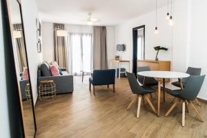 a living room with a table and chairs at Los Cardones Boutique Village in Playa de las Americas