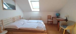 a bedroom with a bed and a table and a desk at Machy Liptov in Liptovská Kokava