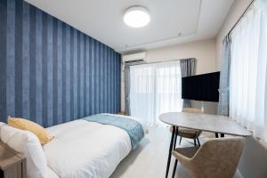 a hotel room with a bed and a table at SPAZIO 6 Hakata Station in Fukuoka +36 photos