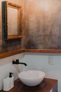 a bathroom with a white sink and a mirror at Casa Sayula Home Cerca De Playa y Centro in Sayulita +11 photos