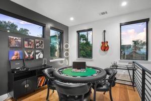 a home office with a round table and chairs at The ATX South Lamar Creekside Retreat with a pool in Austin