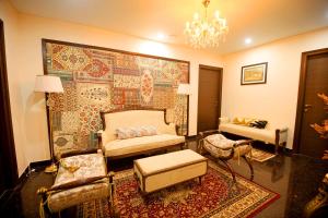 a living room with a couch and a rug at Palm Residences and Suites in Jaipur