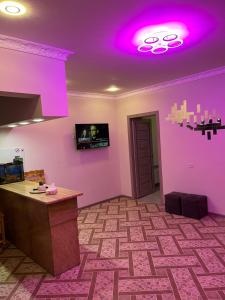 a room with purple lights on the ceiling and a counter at Ners House in Garni