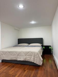 a bedroom with a bed in a white room at Calm Retreat in Plainview