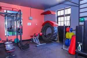 a gym with a tire in the corner of a room at Milimani Empiris Apartments in Nakuru
