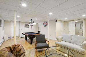 a living room with a pool table and a couch at Northern Lights: 3 br, fireplace, free ski shuttle, a/c, walkable Village location in Stowe